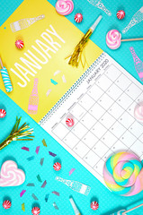 On-trend 2020 calendar page for the month of January modern flat lay with seasonal food, candy and colorful decorations in popular pastel colors. Vertical. One of a series for 12 months of the year.