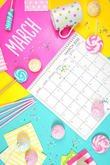 On-trend 2020 calendar page for the month of March modern flat lay with seasonal food, candy and colorful decorations in popular pastel colors. Vertical. One of a series for 12 months of the year.