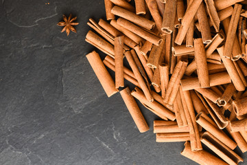 Cinnamon background. Pile of cinnamons stick top view.