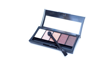 Eyeshadow palette for brown eyes and brush on a white background