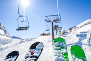 Ski lift in the dolomity mountains. Skis in the air at winter day. Cinque torri location.