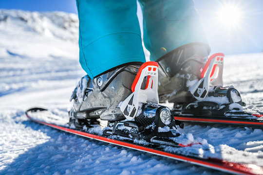 Winter skis and detailed view of the ski bindings concept in sunny day.