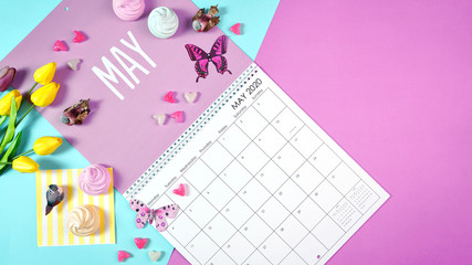 On-trend 2020 calendar page for the month of May modern flat lay with seasonal food, candy and...