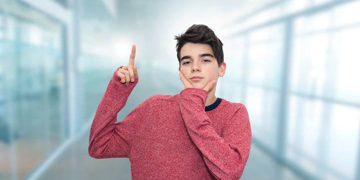 Portrait Of Young Or Thoughtful Student Raising Hand