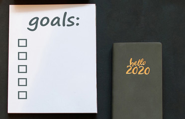 2020 new year goal, plan, action on notepad with office accessories. Business motivation. Inspiration concept.