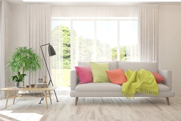 Stylish room in white color with sofa and summer landscape in window. Scandinavian interior design. 3D illustration