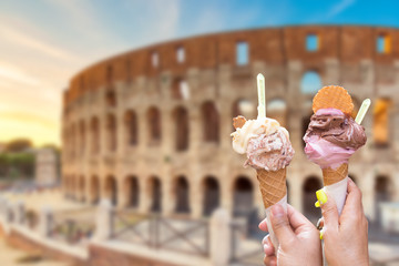 Colosseum at sunset in Rome, Italy with italian ice cream gelato in hands. World famous landmark in...