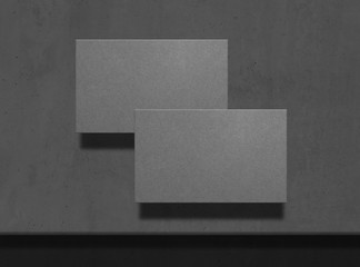 Mock up of two grey business cards on concrete background. Template for corporate identity. Empty objects to place your design. Top view. 3d illustration.