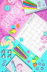 On-trend 2020 calendar page for the month of September modern flat lay with seasonal food, candy and colorful decorations in popular pastel colors. Vertical. One of a series for 12 months of the year.