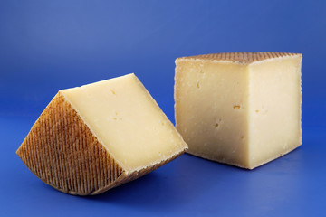 Cured Manchego cheese, derived from sheep's milk.