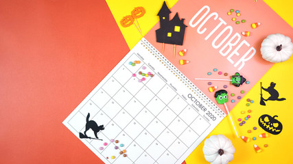 On-trend 2020 calendar page for the month of October modern flat lay with seasonal food, candy and colorful decorations in popular pastel colors. Copy space. One of a series for 12 months of the year.