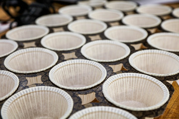 Cups ready for dough in bakery