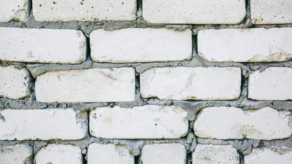 Fototapeta premium Brick walls background with a concrete texture between stones. Renovation and repair works of the building house.