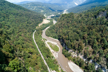 Fototapeta na wymiar mountain fast bubbling river between the rocks, river flow, top view