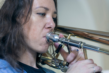 Obraz premium Young woman with a saxophone. Burning brunette. Musician with an instrument.