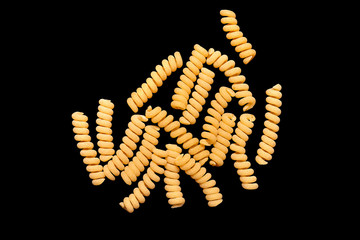 pasta from durum wheat curls fusilli, cavatappi, unprepared, raw pasta handmade on black background isolated