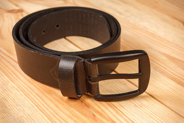 leather men's trouser belt on wooden background