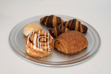 Close up freshly baked pastry goods on display in bakery shop