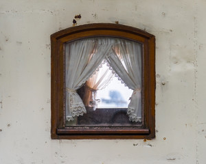 In the middle the old wooden window of the ship