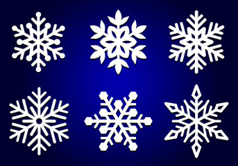 Set of laser cutting openwork snowflakes. Vector silhouette of christmas decoration. Template for paper isolated on blue background. Stencil for scrapbooking, carved wood.