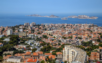 Fototapeta premium Marseille, France. Aerial panoramic view of the city, the bay and islands from the top of the hill in a summer sunny day. Holidays in France.