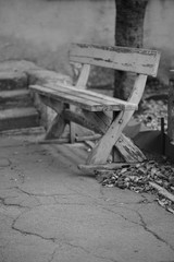 Old wooden bench with peeling paint, bw photo.