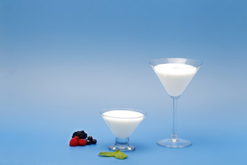 Tubs of natural yogurt, derived from cow's milk.