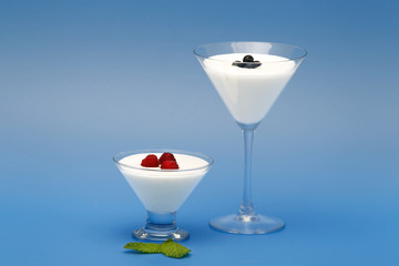 Tubs of natural yogurt, derived from cow's milk.