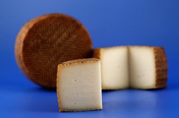 Cured Manchego cheese, derived from sheep's milk.