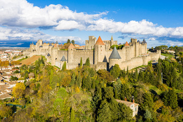 Fototapeta na wymiar Aerial view of Cite de Carcassonne, a medieval hilltop citadel in the French city of Carcassonne, Aude, Occitanie, France. Founded in the Gallo-Roman period, the town is fortified by two castle walls
