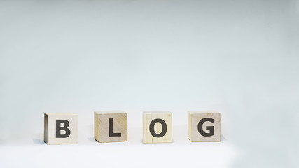 Word BLOG with wooden letters on white background.