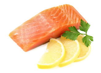 Red fish. Raw salmon fillet with parsley and lemon isolate on white background