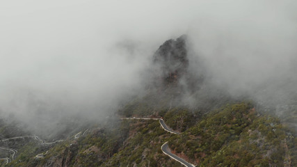 Obraz premium Drone flies through the clouds in the beautiful mountains. Thick clouds, panoramic view of the valley. Tenerphia, Canary Islands, Spain.