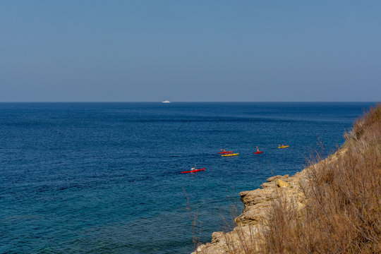 View on a cliff by the sea in Malta with kayaks
