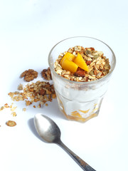 Glass with granola on a white background. healthy eating concept.