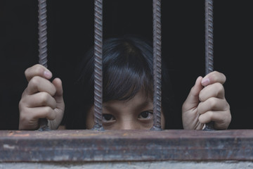 young girl hold cage with eye sad and hopeless, Human trafficking concept, human rights violations, Stop violence and abused children. traumatized children concept.