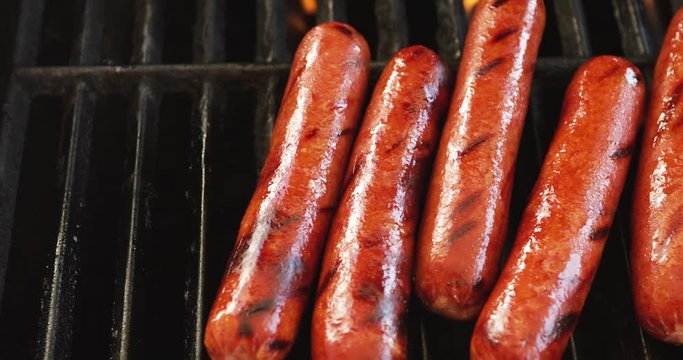 Video Slide While Removing Hot Dogs From Grill