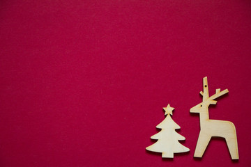 Fototapeta na wymiar Minimal winter creative table flat lay, wooden figures of Christmas tree and deer