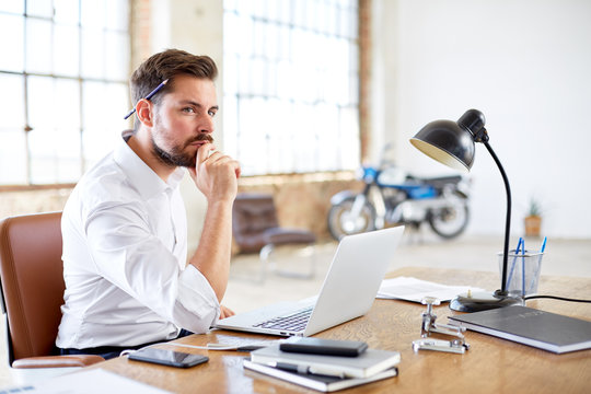 Young businessman thinks about work