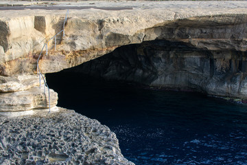 Swimming cave with beautiful dark blue water in Malta