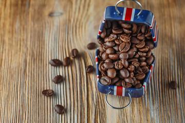 Coffee beans in the small case with britain flag pattern on wooden background