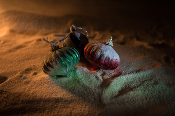 Christmas background with baubles, on snow, free space for text. Christmas decoration