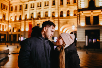 loving couple of travelers in the winter in a European city for Christmas and New Year.