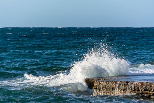 Waves hitting rock platform in Malta