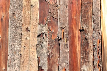 Wooden, unprocessed boards from which the bark peels off.