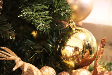 Hanging golden ball on Christmas tree
