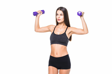 Portrait of a young pretty woman holding weights and doing fitness against white background