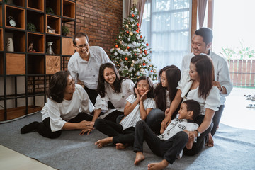 asian family and friend during christmas gathering at home