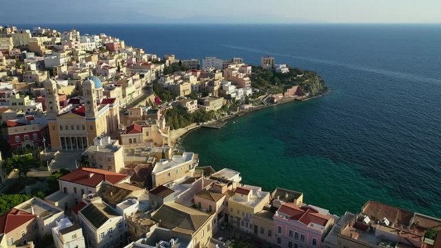 Aerial drone video of picturesque district built by the sea of Vaporia in main town of Syros or Siros island Ermoupolis and famous church of Agios Nikolaos, Cyclades, Greece
