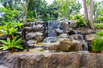 Artificial waterfall and statue at the garden
